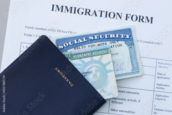 Fototapeta United States passport, social security card and permanent resident (green) card on immigration form. Application to register permanent residence.