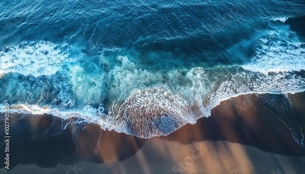 Fototapeta ocean waves and foam splashing, top view of a beautiful transparent clear sea or ocean waves and foam splashing on the dark navy blue