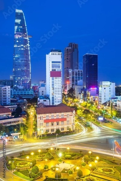 Obraz View of the city after sunset with Bitexco Financial Tower on the background in Ben Thanh Market area, District 1, Vietnam.