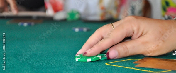 Obraz Hand holding a casino chip