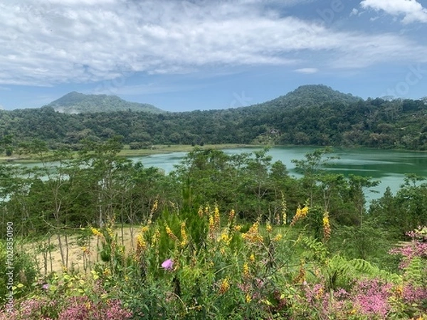 Obraz Serene Lake and Mountains in Manado. A picturesque view of a serene lake nestled between lush mountains.