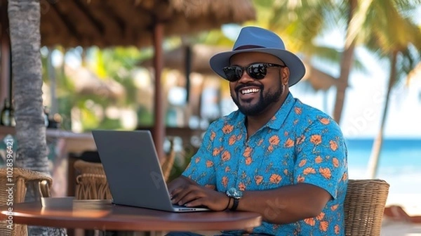 Fototapeta Blacked Man working remotely on beach, digital nomad lifestyle work-life balance virtual remote work Freelance