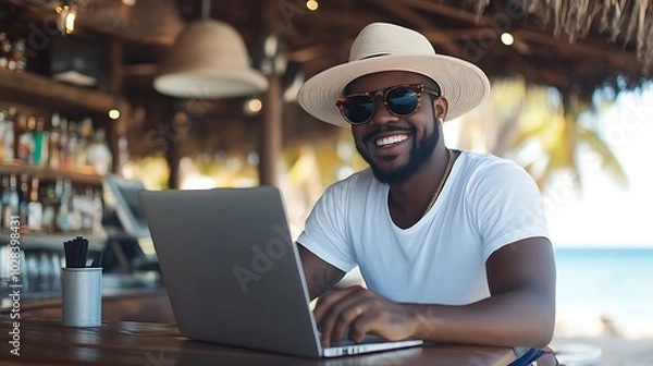 Fototapeta Blacked Man working remotely on beach, digital nomad lifestyle work-life balance virtual remote work Freelance