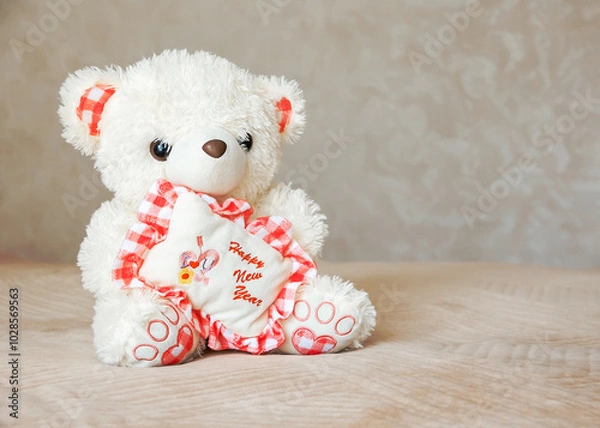 Obraz Two smiling white and brown teddy bears sitting on carpet at sofa and pillows at nursery room. Togetherness and friendship concept. Kids best friends. Closeup.