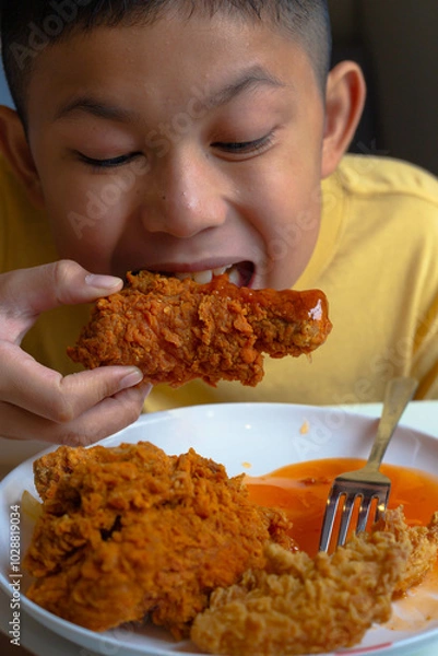 Obraz boy eating fried chicken.