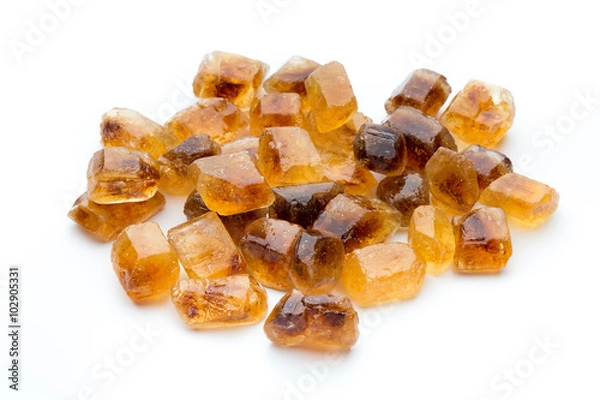 Fototapeta Large caramelized sugar on a white background.