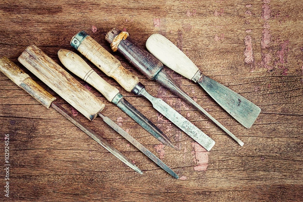 Obraz Old vintage rusty carpenter tools on grunge wooden background in vintage style