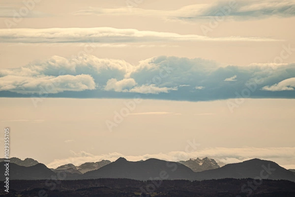 Fototapeta A beautifully cloudy sky with majestic mountains in the background
