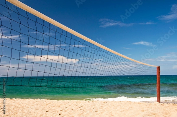 Fototapeta Beach volley net, blue sky and sea in the background