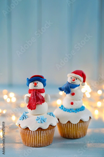 Fototapeta Christmas cupcakes with lights on background