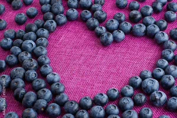 Obraz Heart shaped blueberries scattered on a pink jute tablecloth