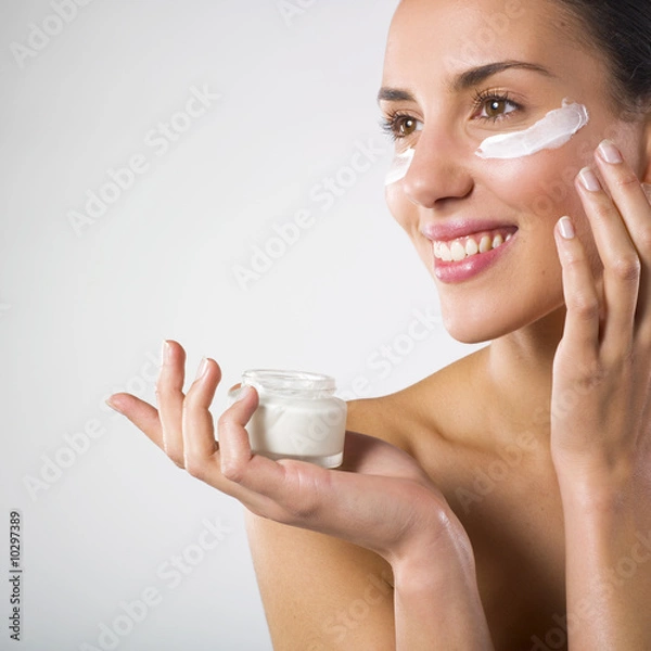 Obraz Woman applying lotion.