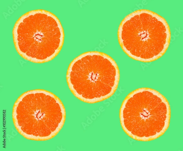Fototapeta grapefruit slices on a green background