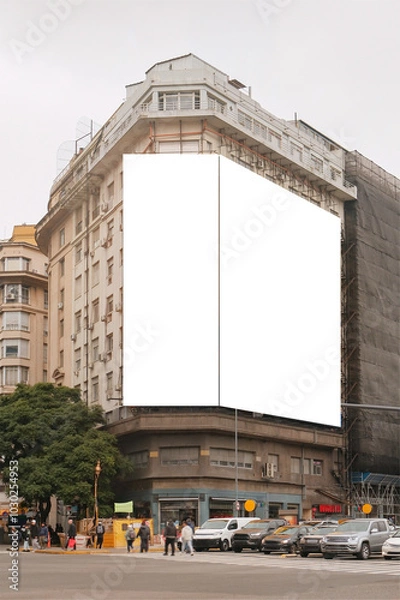 Fototapeta Mock up of giant blank vertical advertising billboards on facade of building located at road junction. Urban city street scene. Out of home OOH advertisement template
