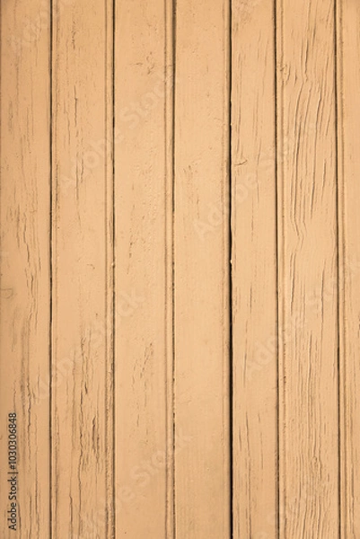 Fototapeta A vertical photograph of old boards tinted yellow with an expressive texture. The paint has peeled off in places due to time and bad weather.