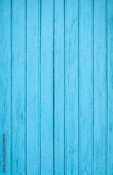 Fototapeta A vertical photograph of old boards tinted blue with an expressive texture. The paint has peeled off in places due to time and bad weather.