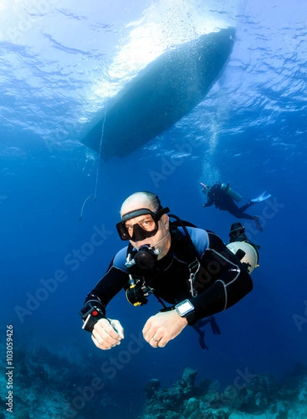 Obraz Sidemount SCUBA Diving below a dive boat