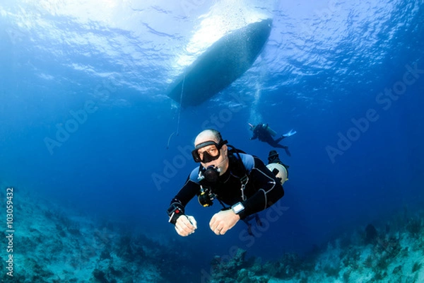 Fototapeta Sidemount SCUBA Diving below a dive boat