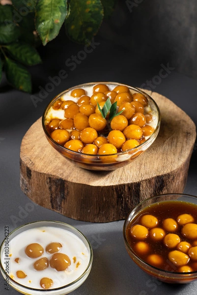 Obraz Candil porridge, with balls of sticky rice flour, drizzled with brown sugar sauce and coconut milk