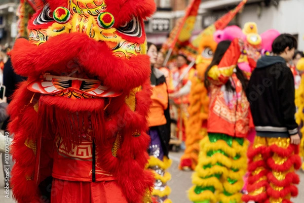 Fototapeta Red lion dancing among de crowd of people as sign on good luck on a Chinese new year festival