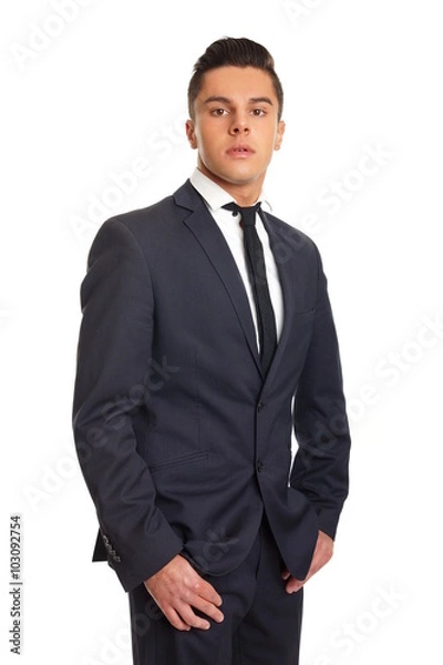 Fototapeta Young businessman in suit standing on white background