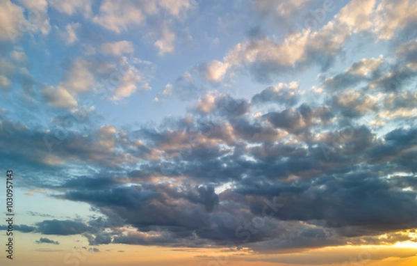 Fototapeta Beautiful cloudscape at sunset, showcasing a vibrant mix of colors and textures in the sky.
