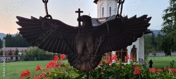 Obraz Bronze cross bearing eagle statue at an orthodox monastery.