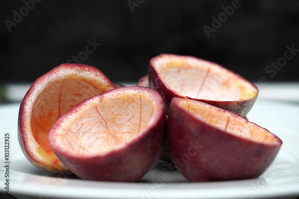Fototapeta Passion fruit half cut empty inside on white dish