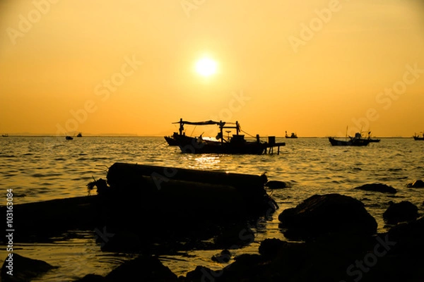 Fototapeta  Silhouettes of boats at sunset – Stock Image