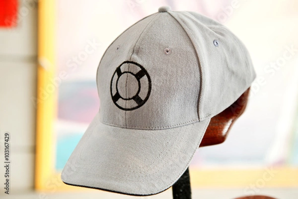Obraz White cap with lifebuoy symbol on front