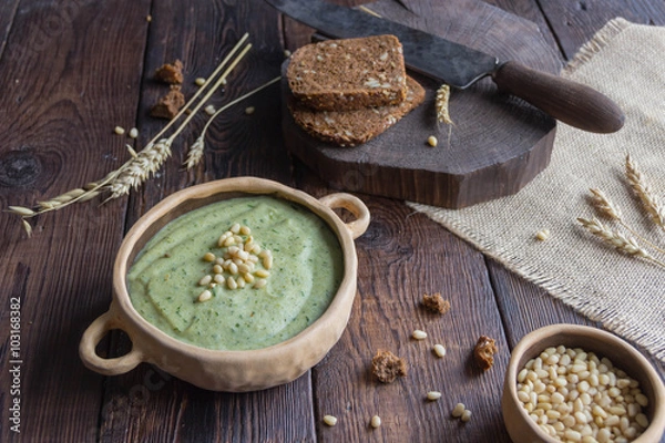 Fototapeta Broccoli cream soup with pine nuts and wholemeal bread, ears of corn, rustic