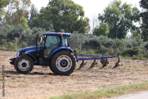 Fototapeta farmer plowing field in autumn
