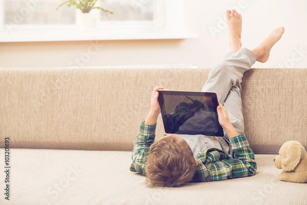 Fototapeta boy playing with digital tablet