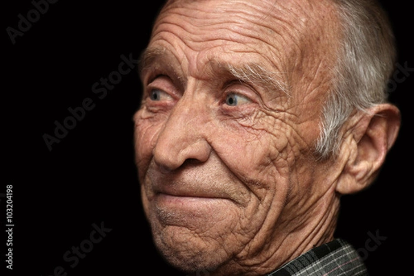 Obraz Cheerful elderly man on a black background
