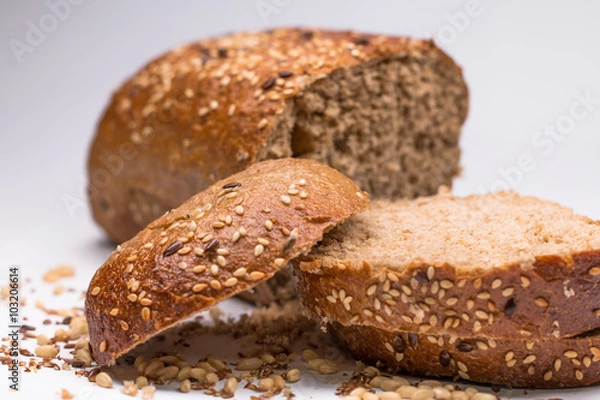 Fototapeta seed bread, a slice cut on white background