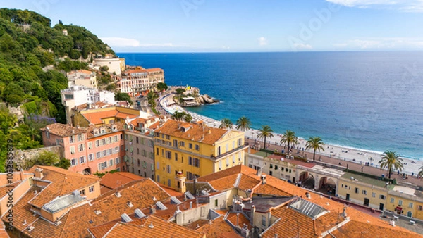 Fototapeta Aerial view of Nice, France, featuring colorful Mediterranean buildings, palm-lined Promenade des Anglais, and the azure waters of the Mediterranean Sea