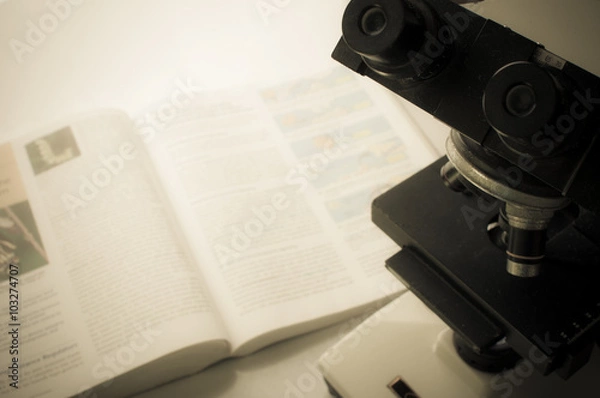 Fototapeta Microscope on table for vintage science background