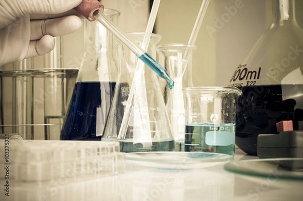 Fototapeta science laboratory test tubes with periodic table background