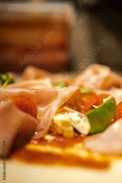 Fototapeta Detailed view of a pizza slice loaded with toppings. Ideal for menu close-ups or food promotions.