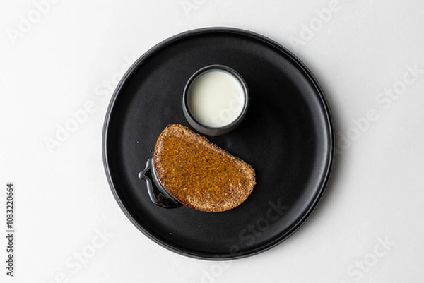 Fototapeta Simple Rye Bread with Honey and Milk on dark plate white background