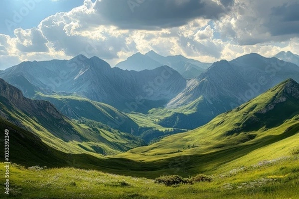 Fototapeta A panoramic view of a mountain range with rolling green hills and a valley in the distance. The sun is shining brightly and there are fluffy clouds in the sky.
