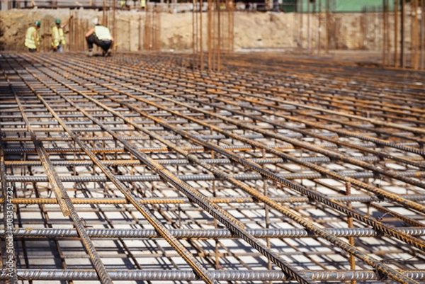 Fototapeta Reinforcement Iron Grate for Pouring Reinforced Concrete Foundation in Construction Site. Preparation Base for Pouring concrete. 
