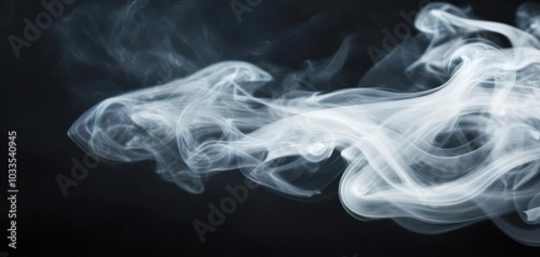 Fototapeta A delicate dance of white smoke swirls against a deep black background, creating an ethereal and mysterious effect