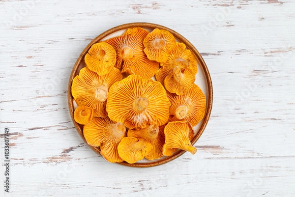 Fototapeta Frozen chanterelles in a plate on the table. Forest mushrooms. Selective focus