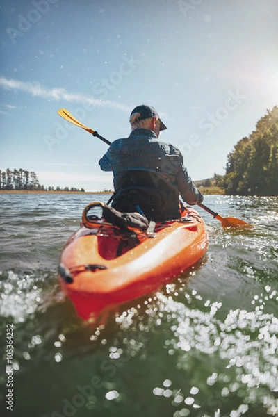 Fototapeta Mature man canoeing in a lake