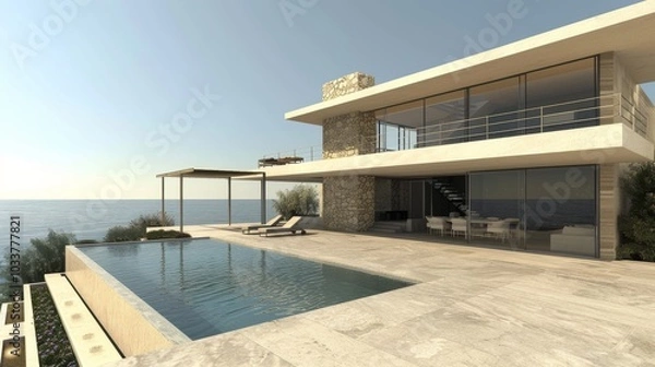 Fototapeta A contemporary two-story villa by the sea, featuring a spacious terrace and an empty pool area in front. The villa is constructed with stone and glass