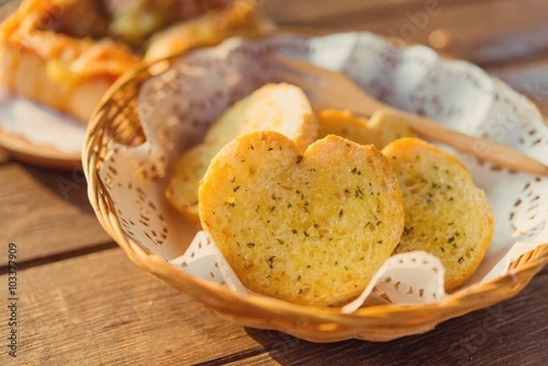 Fototapeta Garlic bread served in baskets on table