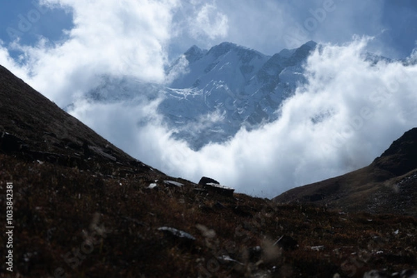 Fototapeta Majestic mountain partially veiled by clouds