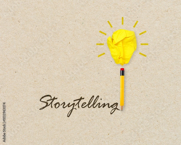 Obraz Yellow lightbulb made of crumpeld paper with pencil writing the word storytelling
