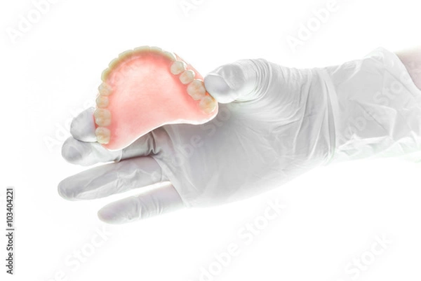 Obraz denture and handglove on white background